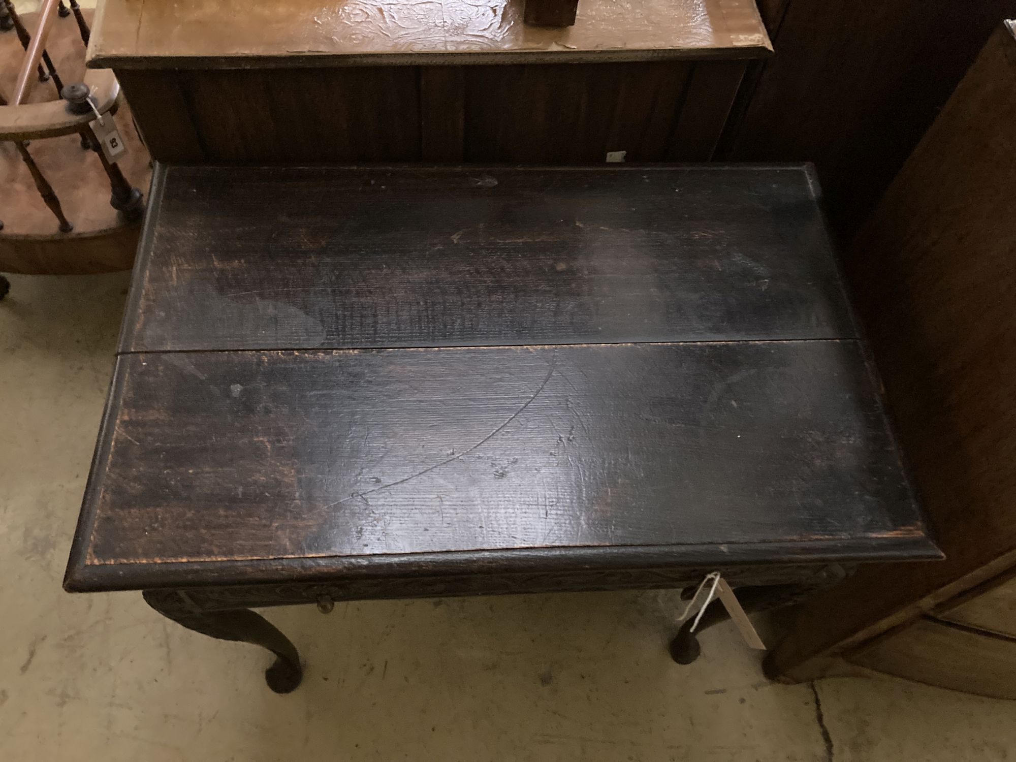 An 18th century oak side table, fitted single long drawers, later carved front, on cabriole supports, width 75cm, depth 47cm, height 66